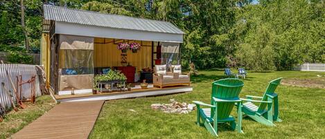 Outdoor Oasis: an outdoor living room with fireplace, TV, and wraparound couch - AND a huge back yard