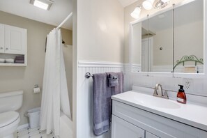 Next to the front entryway is the downstairs bath with shower /tub combo