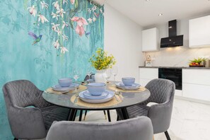 A dining area adjacent to the kitchen, with elegant decor and natural light.
