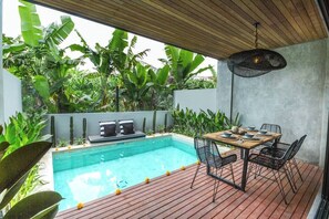 Outdoor space that features private pool and outdoor dining table