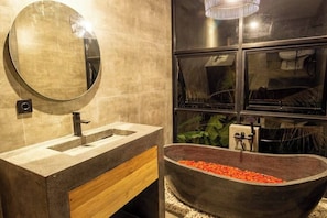 Chic en-suite bathroom with natural stone bathtub