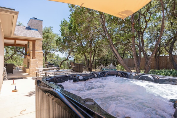 Private hot tub with view of the back yard area.
