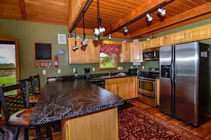 Modern kitchen with all the kitchenware, dining ware and appliances needed.