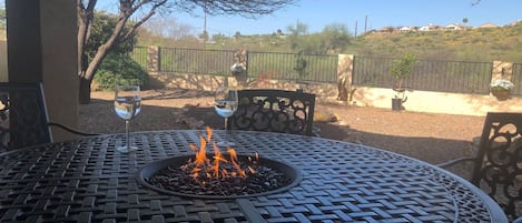 Backyard fire-pit table with view of back yard.