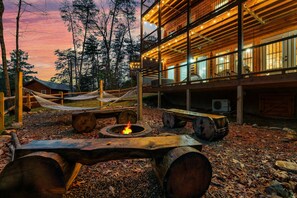 Enjoy the backyard fire pit sitting on three custom made tree trunk benches. 