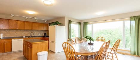 A Unit dining area - seats 8. Beautiful view of mountains out large windows.