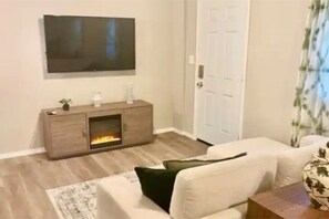 Living area with smart TV and DirecTV. Electric fireplace with light and heat. 