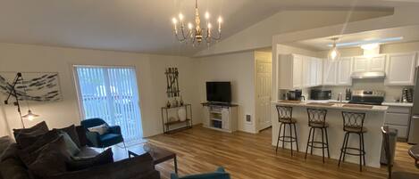 View of living room , kitchen, and dining area from entryway. 