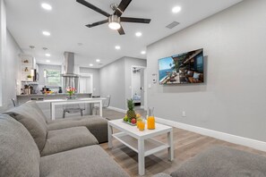 The centerpiece of this room is a large, comfortable couch, designed to provide the ultimate lounging experience.