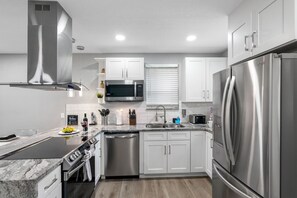 The overall aesthetic is one of modern elegance, combined with the practical features needed for everyday cooking and entertaining.