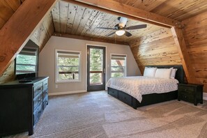 The gorgeous master bedroom is flooded with natural light and features a private balcony with views overlooking the trees.