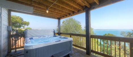 Relax and unwind in the hot tub with breathtaking lake views.