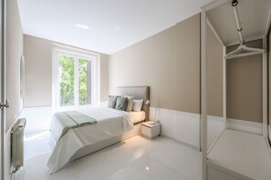 View of the bedroom with double bed and exterior balcony