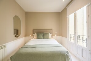 View of the bedroom with a double bed and exterior window