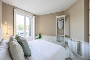 View of the bedroom with double bed and exterior balcony