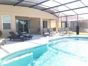 Extended lanai, several loungers and a 6 person patio set!