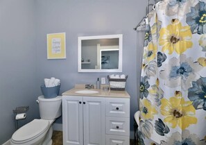 Bathroom has claw tub/shower combo. Freshly laundered towels are in the bathroom.