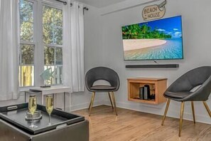 Downstairs living room with accent chairs and Smart Roku TV!