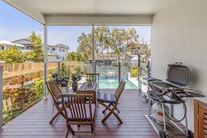 Patio off your lounge overlooking pool. There is a Weber BBQ here.