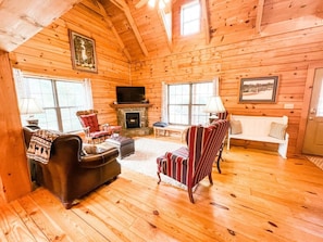 Living room with plenty of sitting area and gas fireplace with Smart tv.