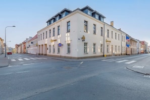 An exterior view of the building showcasing its corner location and classic architecture.
