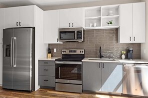 Kitchen appliances include a full-size fridge and dishwasher