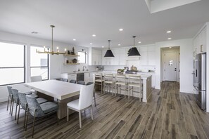 Dining Table & Kitchen - With an open and spacious floor plan, the Dining Room and Kitchen can accommodate meal preparations for groups large or small.