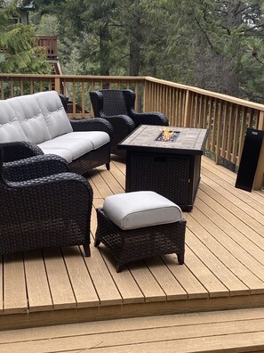 Seating area on the upper deck with a fire pit table 