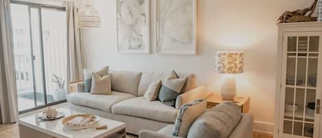 Light filled living room with west facing balcony for beautiful sunsets