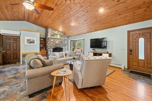 Open-concept kitchen, living, and dining space with high ceilings.