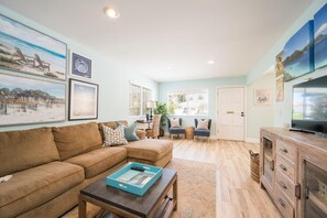 Livingroom with an oversized sectional couch and a small seating area