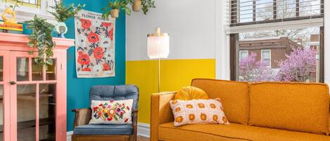 Welcome to our bright a vibrant living room. This is a great place to relax!