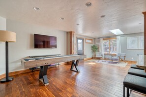 Complete game room, including wood shuffleboard table. 