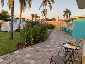 Outdoor patio facing pool and garden