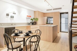 A dining table in the living area allows guests the space to come together for a shared meal.