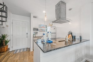 Interior - Spiral stairs/unit entrance/kitchen