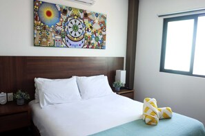 Bed with a blue sheet and a yellow star in Playa del Carmen accommodation