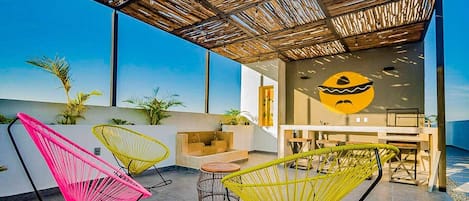 Spacious room with tables and chairs - the perfect space for gatherings in Playa del Carmen.