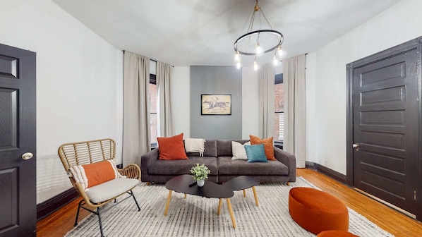 In our living room there is a big comfy sofa for up to 4 people, an extra chair, a coffee table, and two small round chairs.