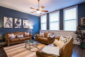 Experience the beauty of natural light and open space in this stunning living room with oversized windows and luxurious but comfortable furniture.
