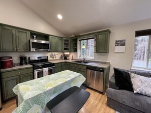 The kitchen is well-stocked with dishes and appliances! 