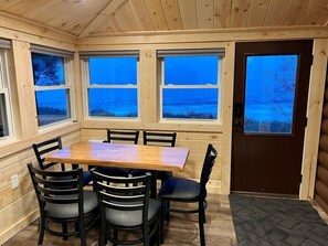 Dining area with windows surrounding.