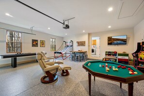 The garage is converted into a game room with baseboard heat, a smart tv and fun for all ages.  Whether they choose Pac-Man, shuffleboard, bumper pool, or pop-a-shot, your kids will have something to do - even on rainy days!