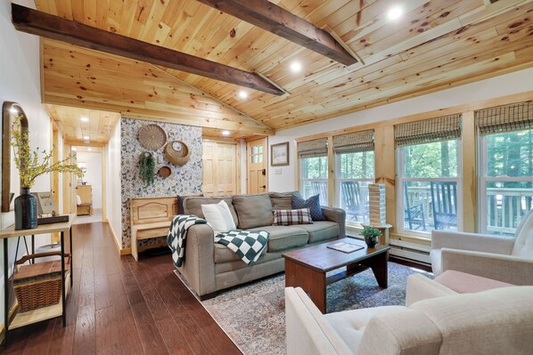 Main living space with large windows, overlooking the front porch. 