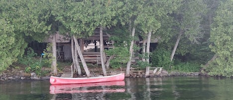 The canoe tied at the small landing dock