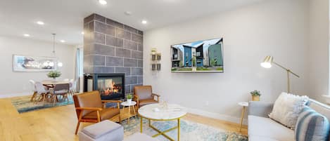 Living Room. Three-sided fireplace shared between the Kitchen and Dining Room.