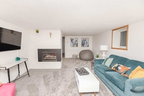 Cheerful living room to relax by the electric fireplace