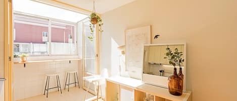 Bright main area with a laundry room, living room and dining area #luminous #airbnb