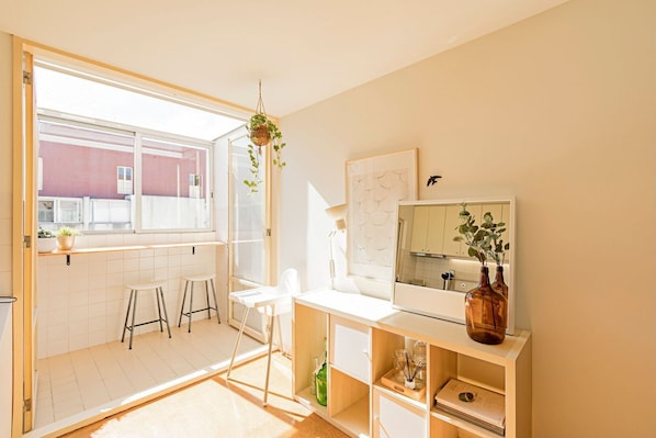 Bright main area with a laundry room, living room and dining area #luminous #airbnb