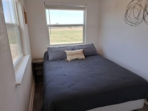Private bedroom with Queen bed and ceiling fan.